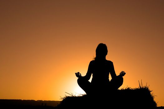 Woman silhouette making yoga