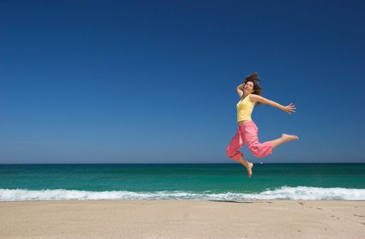 beautiful woman jumping in the beach