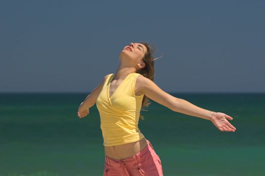 Beautiful woman making poses in the beach