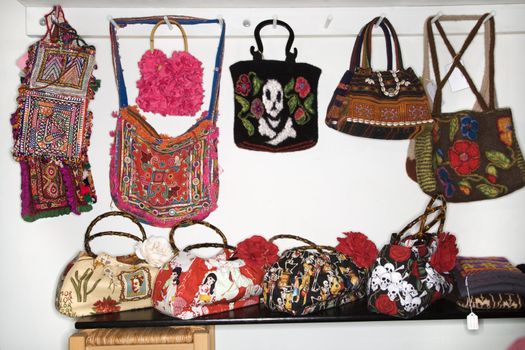 Unique handbags hanging in retail store.