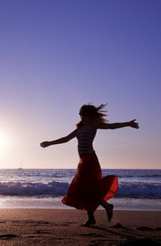 Beautiful woman dancing in the beach