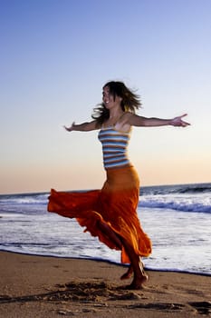 Beautiful woman dancing in the beach
