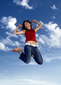 Young beautiful woman jumping to the sky
