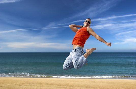 Man jumping on a the beach with a beautiful cloudy sky