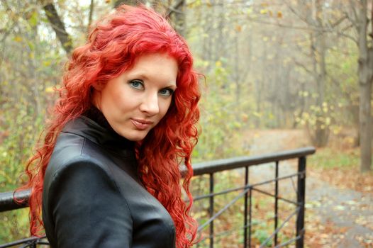 red hair gothic style woman over autumn background