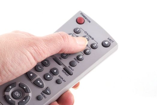Hand with remote control isolated on white.