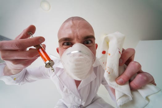 Ominous doctor with syringe in the hand 