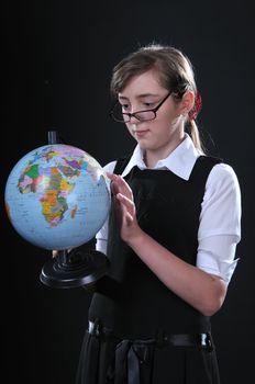 Schoolgirl of ten years in glasses gets on the hip student's globe