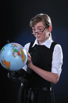 Schoolgirl of ten years in glasses gets on the hip student's globe