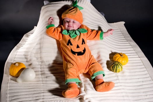 Baby dressed in pumpkin suit