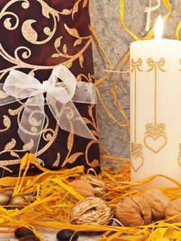  decoration with candle and nuts against beige background 