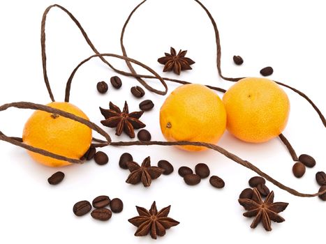  mandarines with decorations of anise stars, coffie and cord against white background 