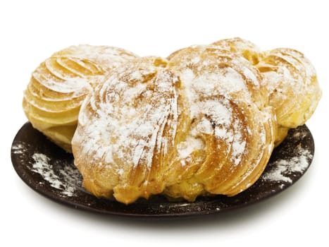 Tasty buns with sugar powder against the white background 