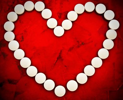 tablet heart against abstract red background