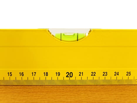 yellow level on the brown wooden plank