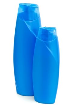 two plastic blue bottles of shampoo over white