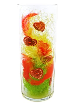 decorative hearts in glass vase against white background