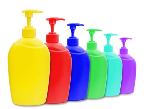 different multicolored plastic bottle of liquid soap over white