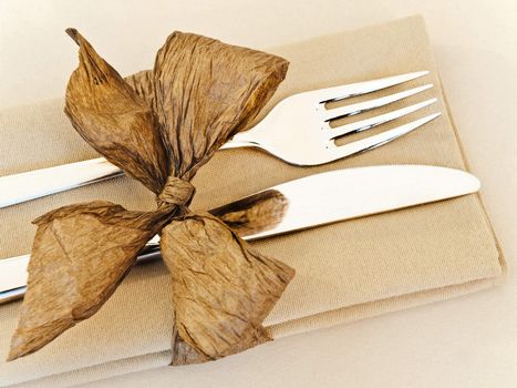 decorated table serving with golden bow in serviette 