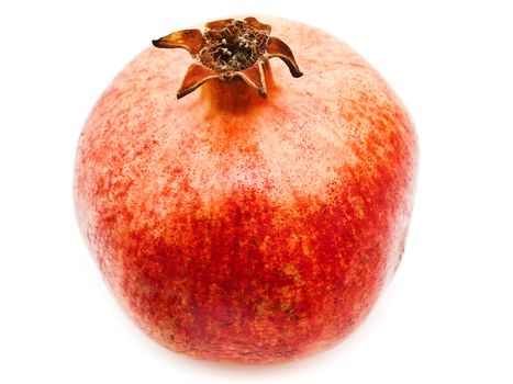 Single red pomegranate over the white background