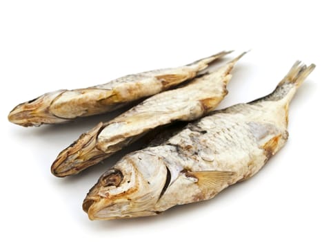 three dried fishes over the white background
