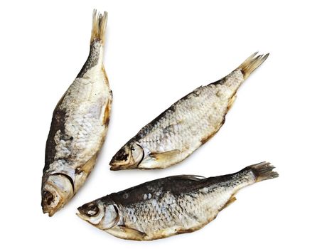 three dried fishes over the white background