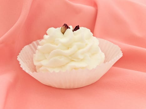 white aerial pastry against pink textile drapery
