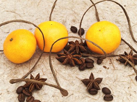decoration with mandarins, anise stars and coffee beans against beige background  