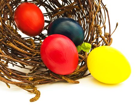 easter nest with multicolored eggs against white
