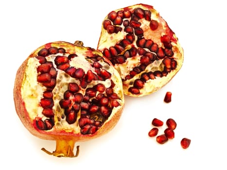 broken ripe pomegranate over the white background