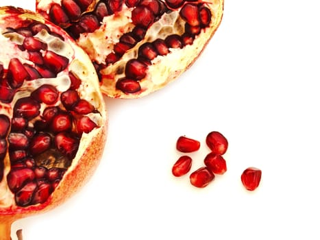 broken ripe pomegranate over the white background