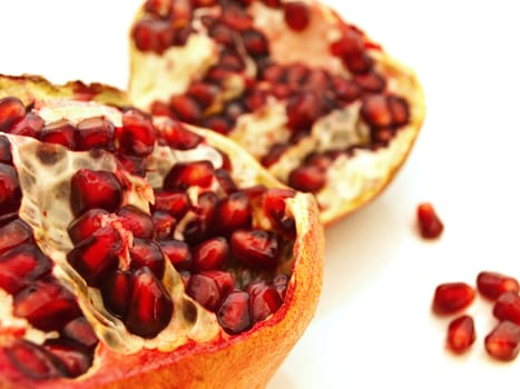 broken ripe pomegranate over the white background
