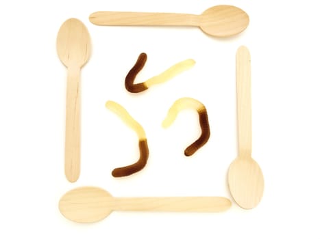 wooden spoons with amazing colorful tasty jelly candies against white background