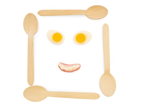 wooden spoons with amazing colorful tasty jelly candies in face shape