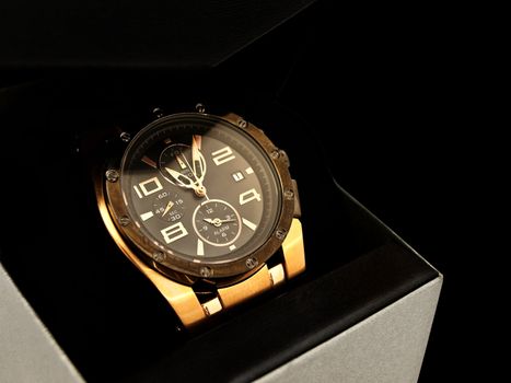 luxury man clock in gift box against black background