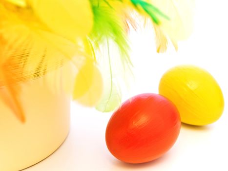 Bright easter composition with eggs and multicolored feathers