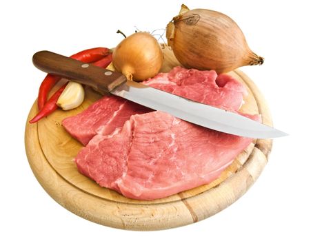 pieces of meat with kitchen knife and some spices