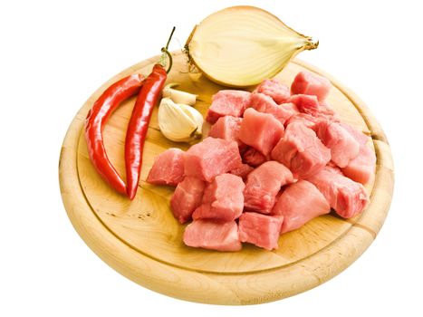 pieces of meat with pepper,garlic and onion on hardboard