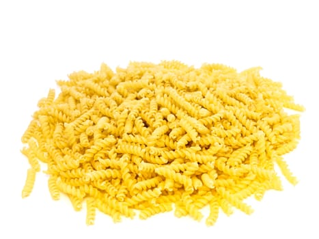 yellow spiral pasta over the white background