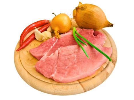 piecies of meat with different vegetables on the hardboard