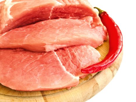 piecies of meat and pepper on the hardboard over white