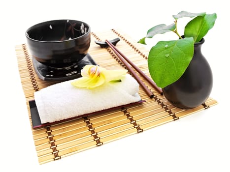 oriental style table serving with orchid and green leaves