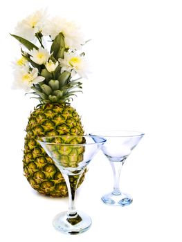 ripe pineapple with white flowers and glass