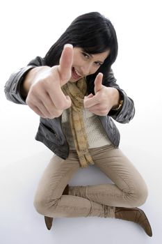 sitting woman showing approval sign against white background