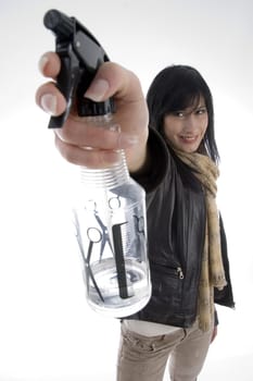 female with spray bottle against white background