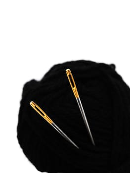 two needles with golden needle's eye in the black clew