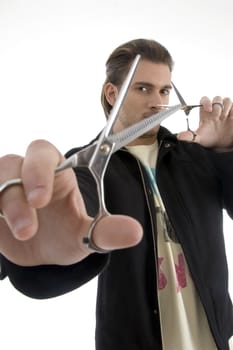 hair stylist holding a pair of scissors against white background