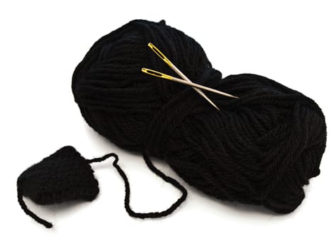 two needles with golden needle's eye in the black clew