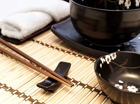 oriental style table serving with chopsticks on bamboo mat