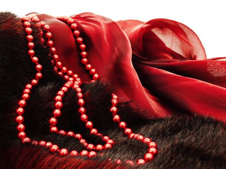  fashion red necklace in chaplet shape over burgundy textile and fur  background
